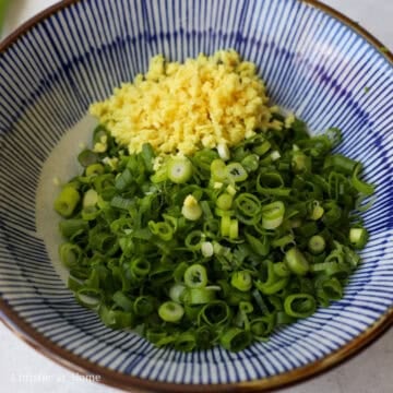 Add finely chopped scallions and minced ginger to a bowl.