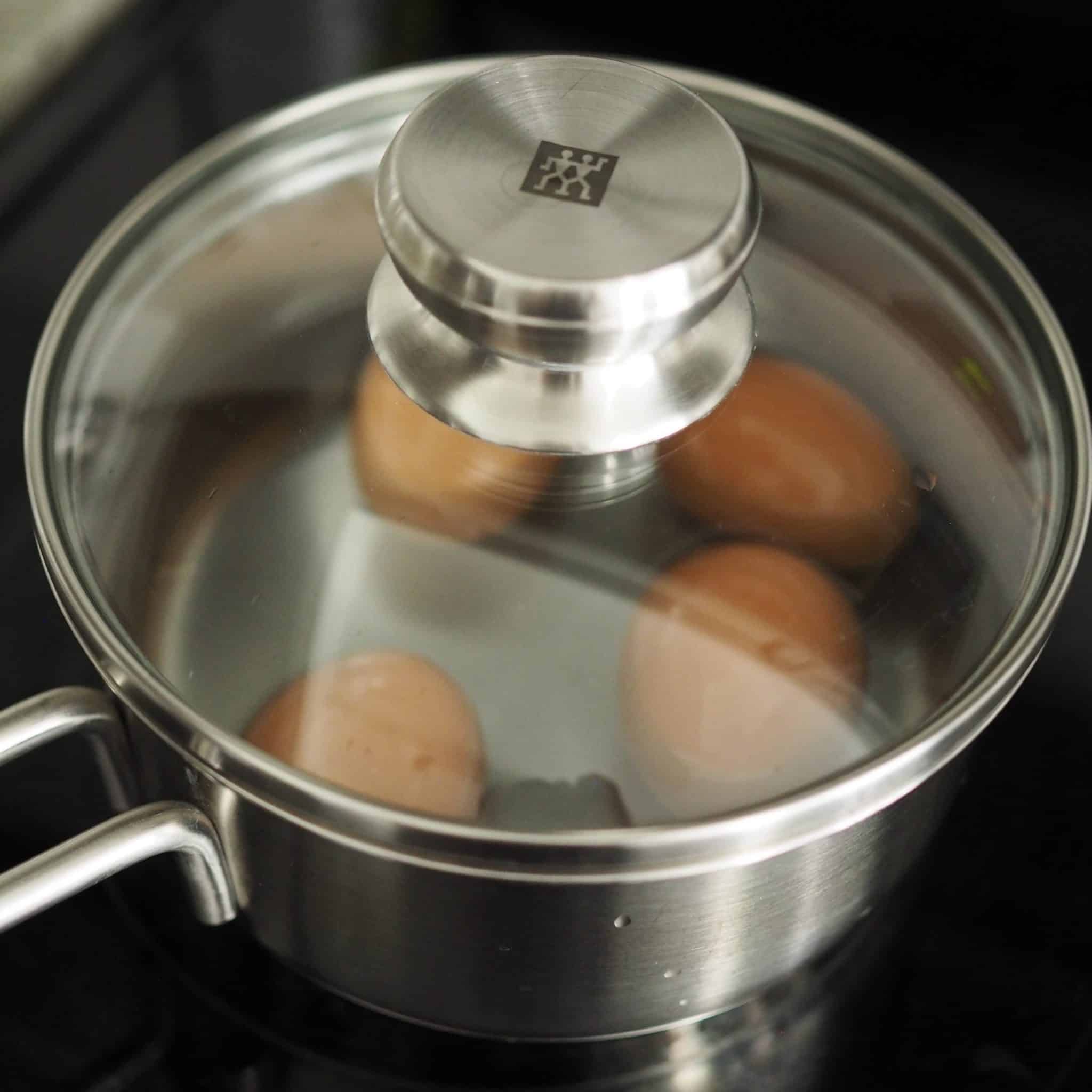 bring the pot of water with the eggs to boil on medium-high heat for 5 minutes covered and chill in an ice bath