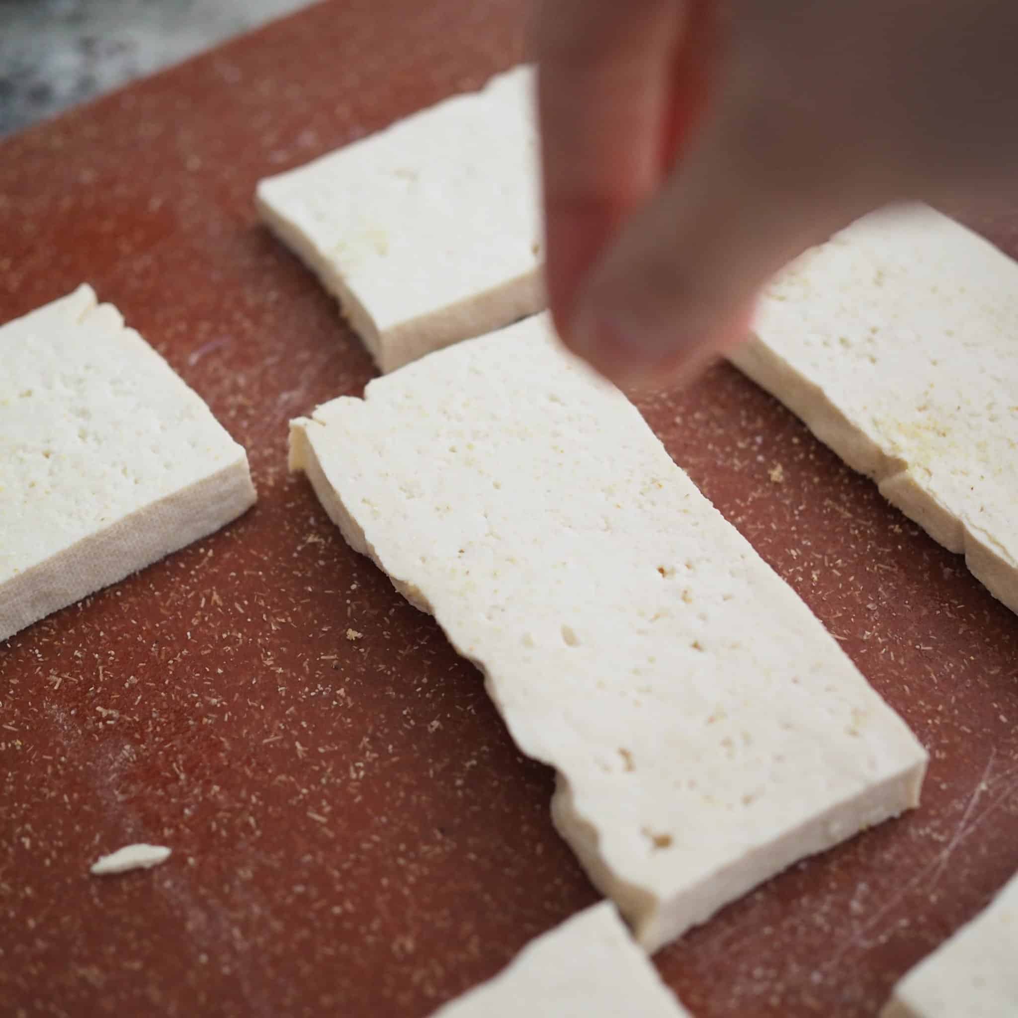Generously season each piece of tofu salt and garlic powder on both sides.