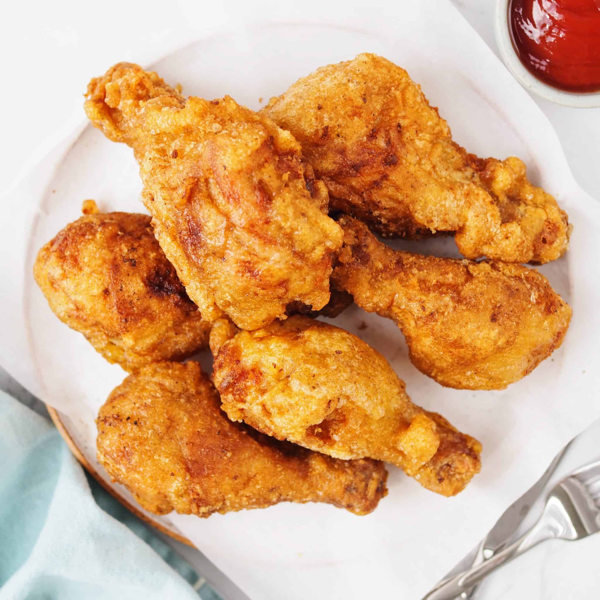 Finally transfer fried chicken to a wire rack or a paper-towel lined baking sheet to remove excess oil.