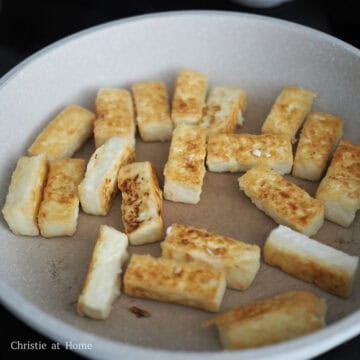 Heat vegetable oil in a large non-stick pan set on medium heat. Pan-fry tofu until crispy and golden brown on all sides, about 12-15 minutes in total.