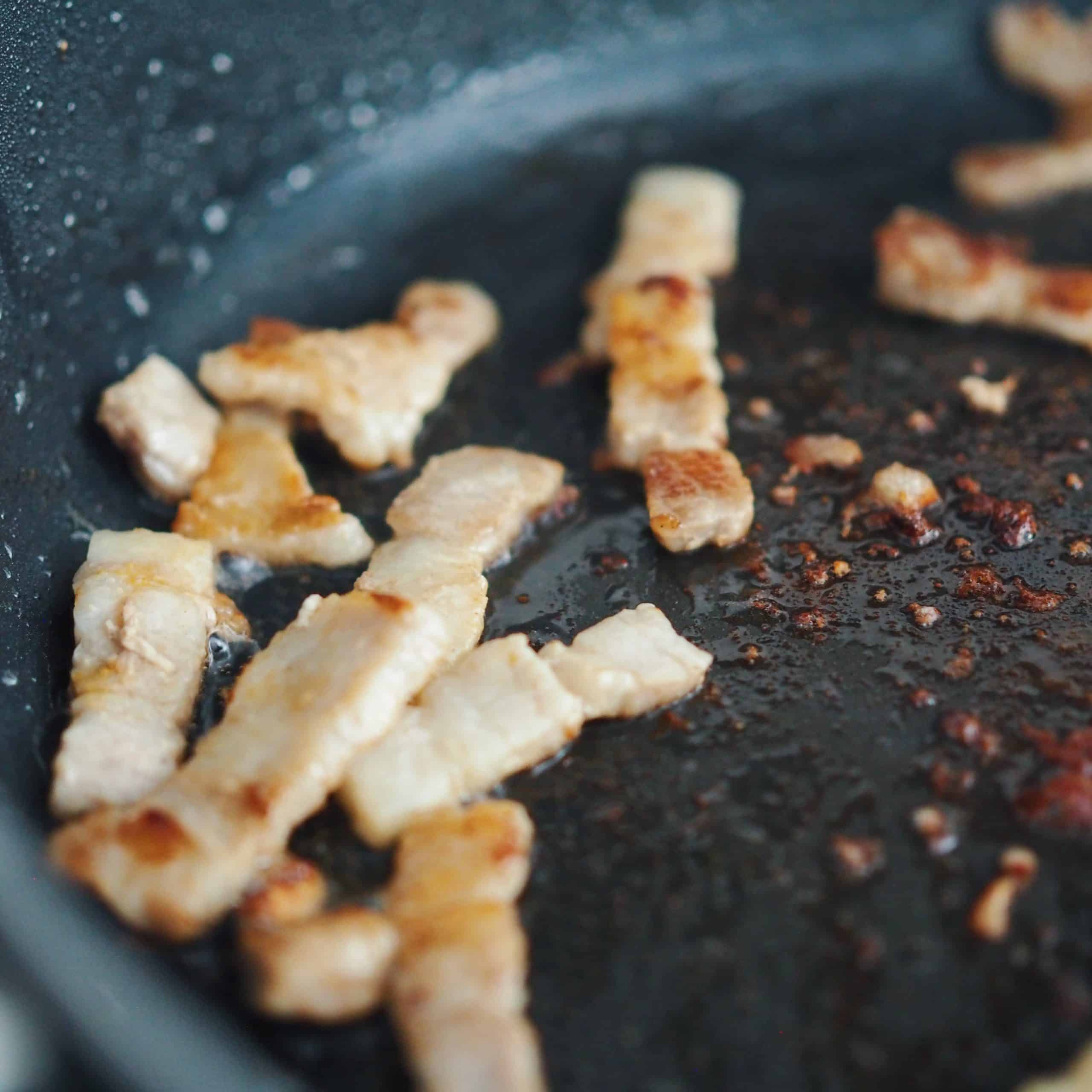 In a large pan on medium heat, fry pork belly until golden crispy brown, about 5 minutes.
