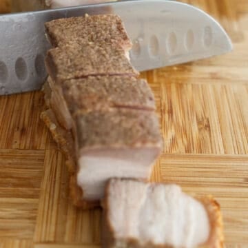 Turn the pork belly skin side down on a cutting board. With a sharp knife, slice into the meaty side in a sawing motion. Then when you reach the skin, slice down with one swift chop. In a small bowl, combine hoisin and rice vinegar. Serve with pork belly slices.