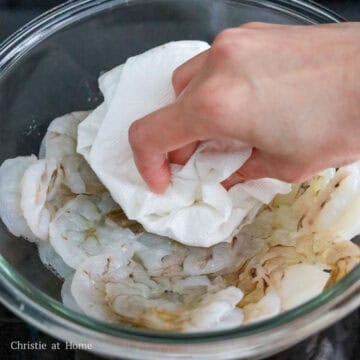 Then transfer the shrimp to a large bowl and pat dry with clean paper towels to remove any excess moisture.