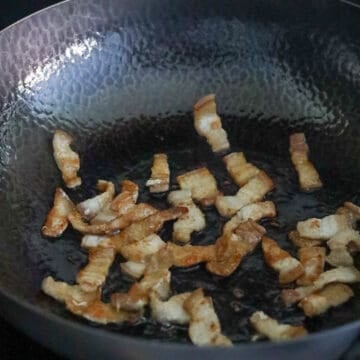 Heat oil in the pan and cook pork belly.