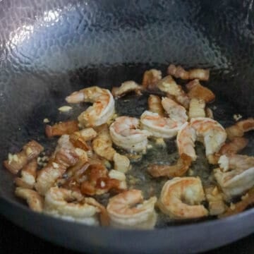 Add garlic and shrimp. Partially cook the shrimp until mostly pink and translucent in the center.