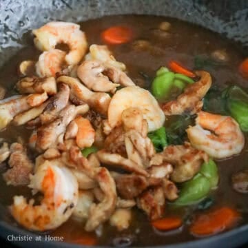 Increase to medium-high heat, cook bok choy, carrots, mushrooms and green onions for 1 minute. Pour in the noodle sauce and bring to a simmer to thicken. Then toss back in the cooked chicken and shrimp and stir fry for another minute.