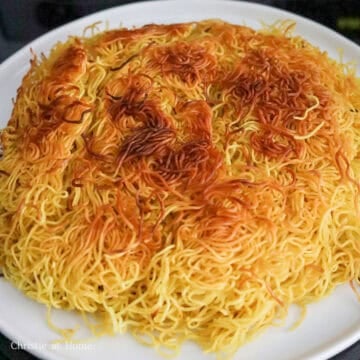Flip over noodles and pour another ¼ cup or 60 ml of vegetable oil around edges of the noodles. Fry until golden crispy and rotating it occasionally. Slide the crispy noodle pancake onto a large serving plate.