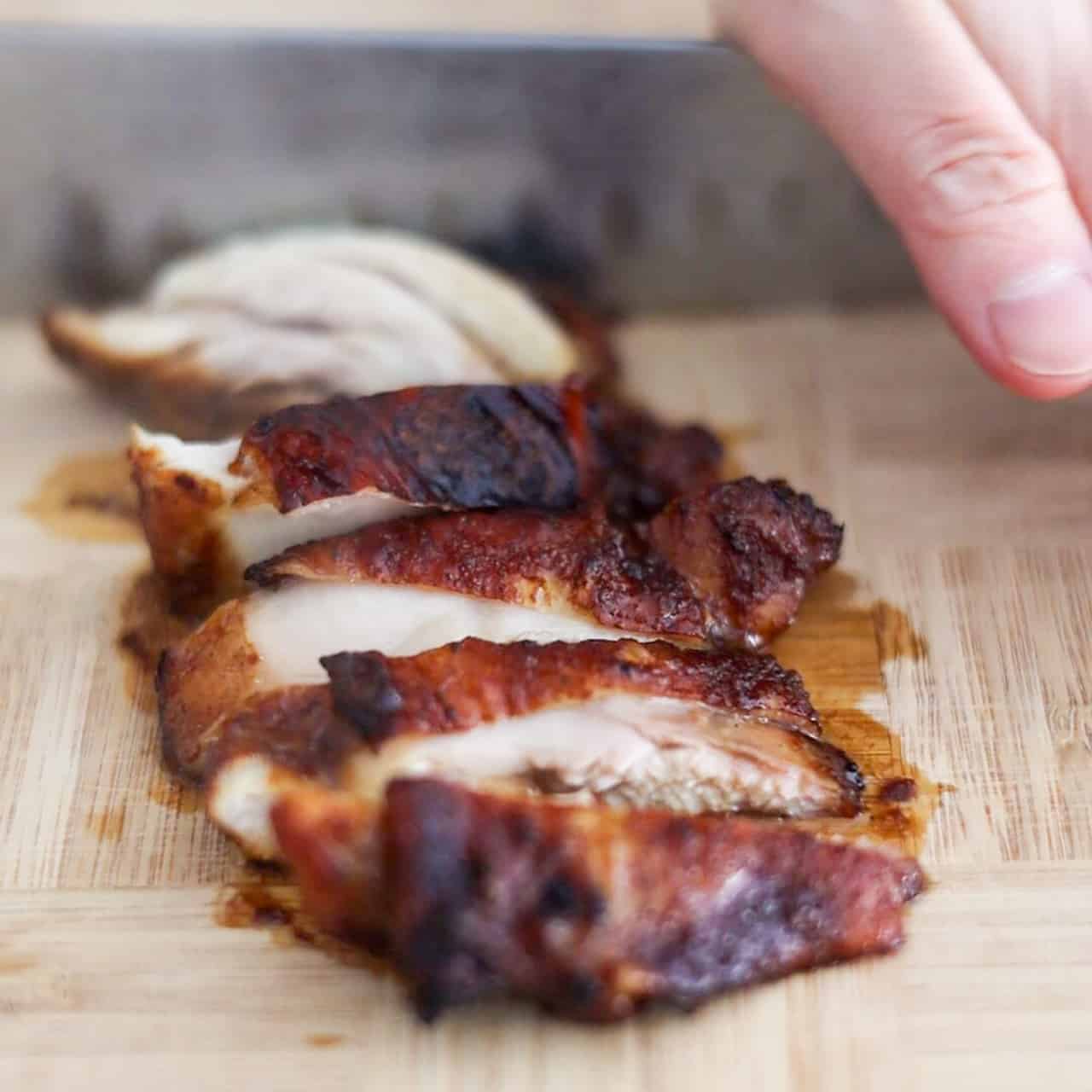 Remove and transfer cooked chicken thighs to a cutting board and slice into smaller pieces.