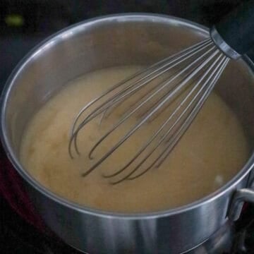 On medium heat, mix miso paste into the dashi broth until combined with a whisk to break down the paste more quickly.