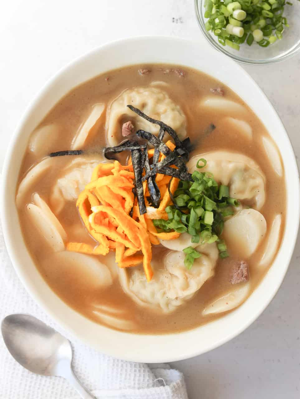 Divide and serve the soup into large bowls. Garnish with cooked eggs strips, green onions, and gim. Feel free to season with a pinch of salt to taste if you'd like it saltier.