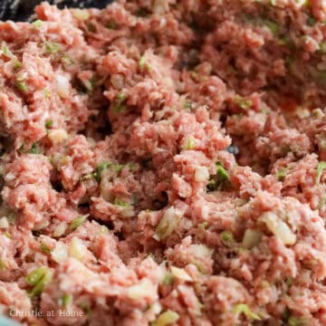 Into a large mixing bowl, add cabbage and remaining filling ingredients as listed above. Mix in one direction with chopsticks or a fork until the filling becomes a sticky paste. (Optional: microwave or cook 1 tablespoon of the filling until cooked through and taste test it adjusting the seasoning as needed).