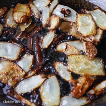 Carefully lower in the ginger, onion, star anise, bay leaves, cinnamon stick and cloves into the hot oil. Simmer on for at least 20-25 minutes for best fragrance. Stir occasionally.