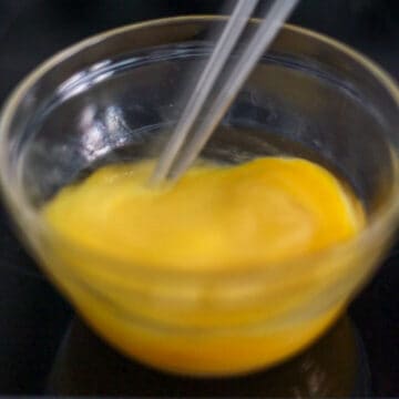 Then in a small mixing bowl, beat eggs and sesame oil and set aside.
