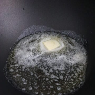 In a wok or large pan on medium heat, melt butter and add vegetable oil to prevent the butter from burning.