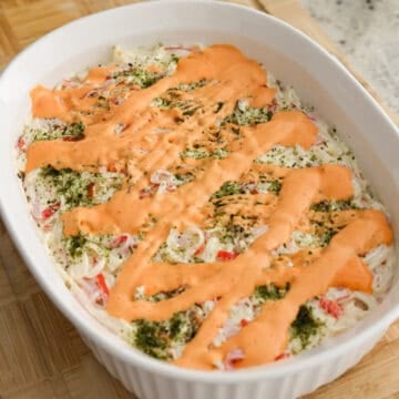 In a small bowl, combine Japanese mayo and sriracha to make a spicy mayo. (Not a fan of spice? Substitute with more mayo and omit the sriracha). Drizzle spicy mayo on top of crab layer.