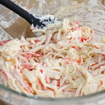 In a large bowl, combine shredded and chopped imitation crab meat with Japanese mayo, and cream cheese.