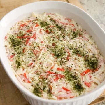 Add crab mixture top of rice. Spread it out evenly and firmly pack it in. Sprinkle the remaining furikake on top of crab meat mixture.