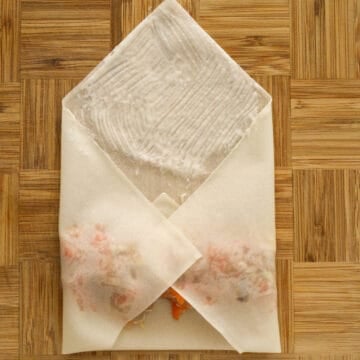 Fold in the side corners over the filling. Lightly brush a bit of the flour water mixture on the top corner.