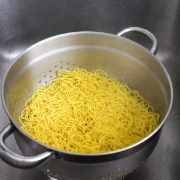 Strain the noodles in a colander and set aside. Do not rinse off with water.