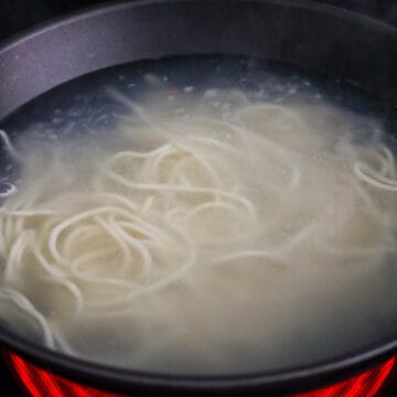 Then in a large pan filled with boiling hot water, blanch noodles for 2 minutes until Al dente and strain immediately. Do not overcook.