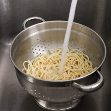 Next rinse noodles under cold running water to remove any excess starch. Shake out excess water.