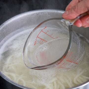 Reserve ½ cup of hot noodle water