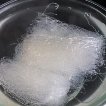 In a large bowl with dried mung bean noodles, add hot boiling water and let this soak for 1-2 minutes just until loosened and slightly softened. Do not over soak!