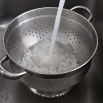 Strain noodles immediately. Rinse off with running cold water and strain out as much excess water as possible.