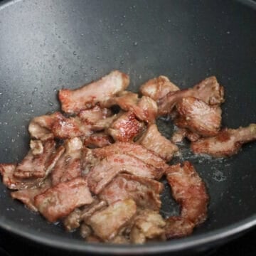 Heat vegetable oil in a large pan over medium heat. Sear the beef until just cooked through with lightly browned edges. Remove and set aside.