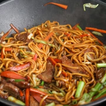 Add the noodles and sauce. Stir-fry until the liquid is absorbed. Return the beef to the pan along with green onions and toss to combine. Remove from heat and serve immediately.