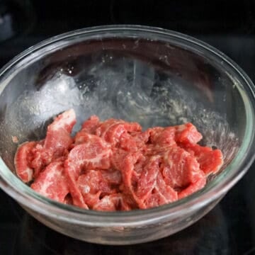 Thinly slice flank steak against the grain on a slight angle into ¼-inch pieces. (For easier slicing, freeze the beef for 45-60 minutes until firm.) Transfer to a bowl and mix with marinade ingredients as listed above. Let sit for 15-20 minutes.
