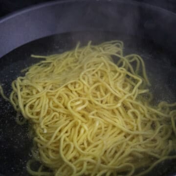 Bring a large pot or wok of water to a boil. Add the noodles and blanch just until loosened, about 30 seconds. Drain, rinse under cold water, and shake off excess moisture. Set aside.
