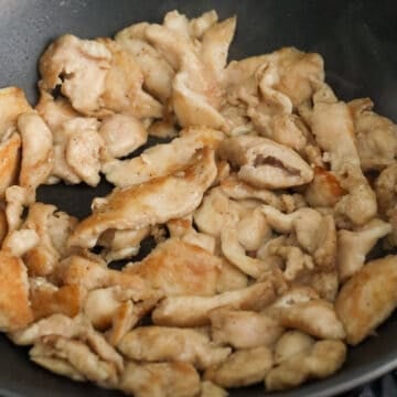 Heat vegetable oil in a large pan on medium-high heat. Fry chicken until cooked and golden. Remove chicken from pan.