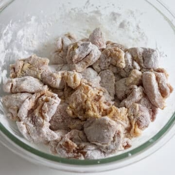 Add cornstarch over the chicken and toss with tongs until each piece of chicken is evenly coated.