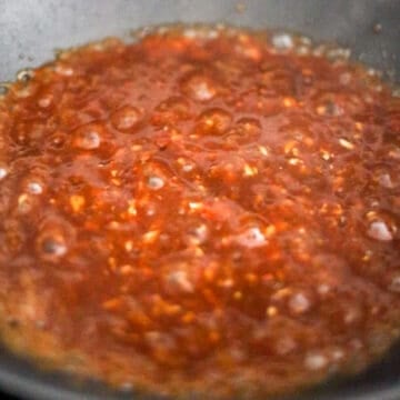 Reduce to medium heat, pour prepared sauce into pan. Simmer to thicken.