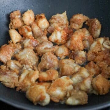 Heat vegetable oil in a large pan on medium-high heat. Fry chicken in small batches until golden brown and crispy, about 7-9 minutes in total. The internal temperature of cooked chicken should be 165 degrees F with a digital thermometer or until juices run clear. Remove and transfer fried rice on a wire rack or on a paper-towel lined plate. Discard any excess oil in the pan.