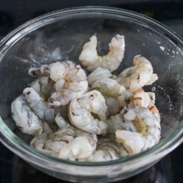 In a large bowl, add peeled and deveined shrimp, season with salt and black pepper. (If your shrimp isn't peeled or deveined, follow my instructions below in the FAQ section on how to do that).