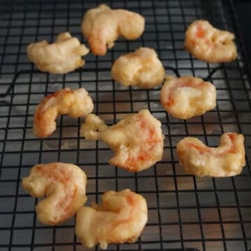 Remove shrimp from hot oil with a slotted spoon or tongs and transfer to wire rack or paper towel lined baking sheet to drain off excess oil. Excess oil creates soggy shrimp.