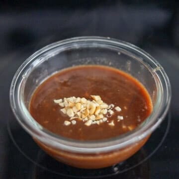 Once the sauce boils, remove off heat and transfer it to a small bowl to cool. Sprinkle crushed peanuts on top of the sauce. Place hoisin peanut sauce in the fridge to chill.