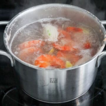 In a medium pot filled with enough hot water, bring to boiling point on high heat. Add the halved shallot and sliced ginger. Then add shrimp with the shell on for extra flavor (or if you’re using peeled shrimp, that will work too). Boil shrimp for 2 minutes or until opaque and no longer translucent.
