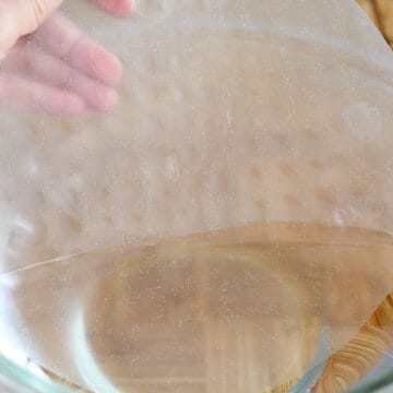 Quickly wet a sheet of rice paper with room temperature water for 1 second on all sides. Do not over soak it or it will become too soft to wrap with ease. The rice paper should still be firm. Place wet rice paper onto a clean work surface.