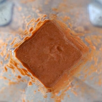 Marinade ingredients being blended in a blender or food processor into a smooth, thick paste.