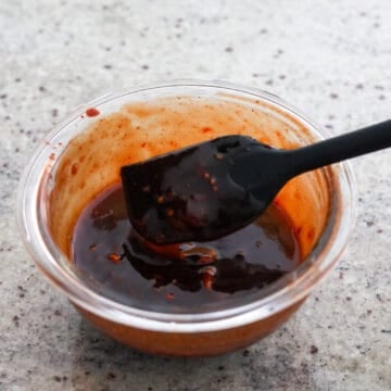 In a separate small bowl, combine basting sauce ingredients as listed above using a fork to smash the fermented red bean curd. Set aside.