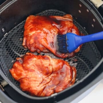Lightly spray the air fryer basket with cooking oil or cooking spray. Place marinated chicken skin side up in a single layer in air fryer basket. Do not overlap. You may need to air fry in small batches. Brush enough basting sauce to cover the chicken skin.