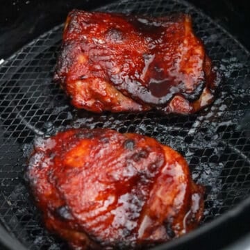 Air fry for 9-10 minutes in total at 375 degrees F. No flipping needed. Cook until an internal temperature of 165F with a digital instant read thermometer inserted into the thickest part of the chicken thigh or until juices run clear.