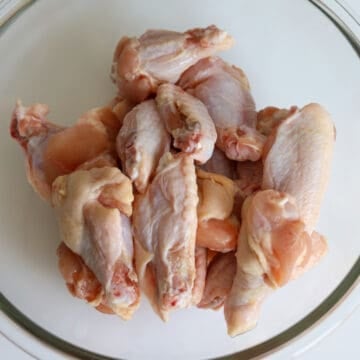 Use clean paper towels to pat dry the wings. The excess moisture will prevent the marinade from sticking to the chicken skin as it's slippery. Transfer chicken wings into a large mixing bowl.