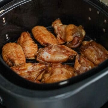Spray enough vegetable oil or any neutral oil into the air fryer basket to prevent sticking. Lay chicken wings in a single layer. Do not overlap.