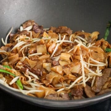 Toss back in cooked beef, bean sprouts, and scallion greens. Gently toss until everything is mixed. Remove off heat. Enjoy!