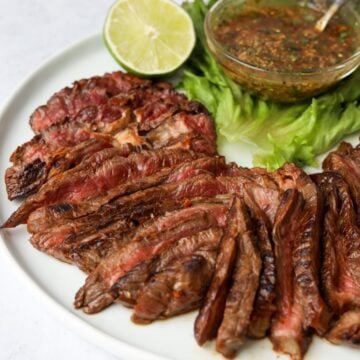 Sliced steaks served with dipping sauce.